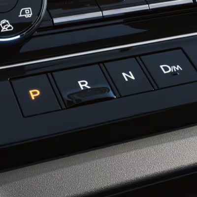 Close-up view of the 2025 Nissan Armada's sleek gear selector with illuminated park indicator.